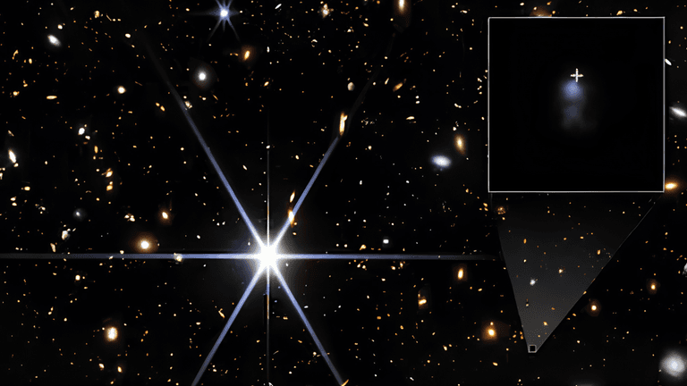 Astronomical image of distant galaxies with a bright central star and inset detail.